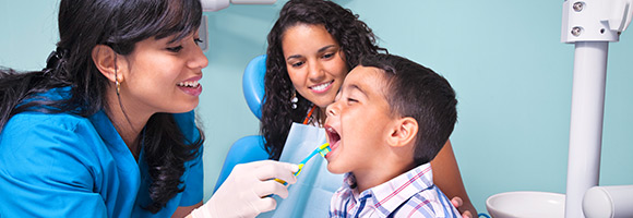 Dentist looking in childs mouth