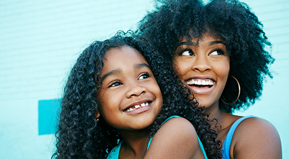 Mom and daughter smiling